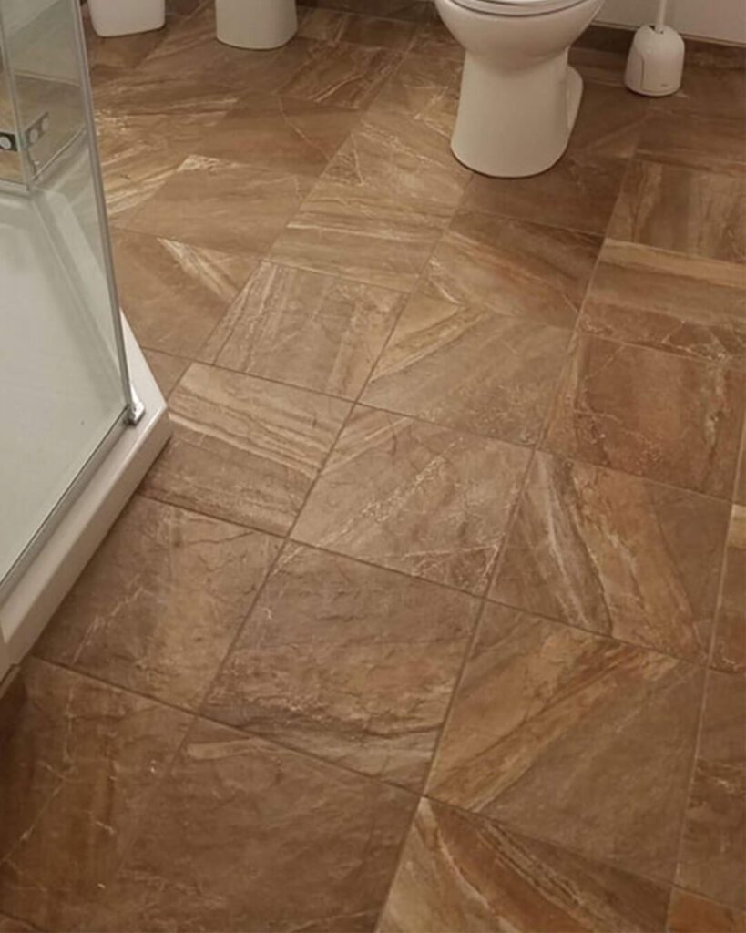 Diagonal brown ceramic tile floor with precision cuts – expert tile installation by Esox Custom Tiling in Madison , WI