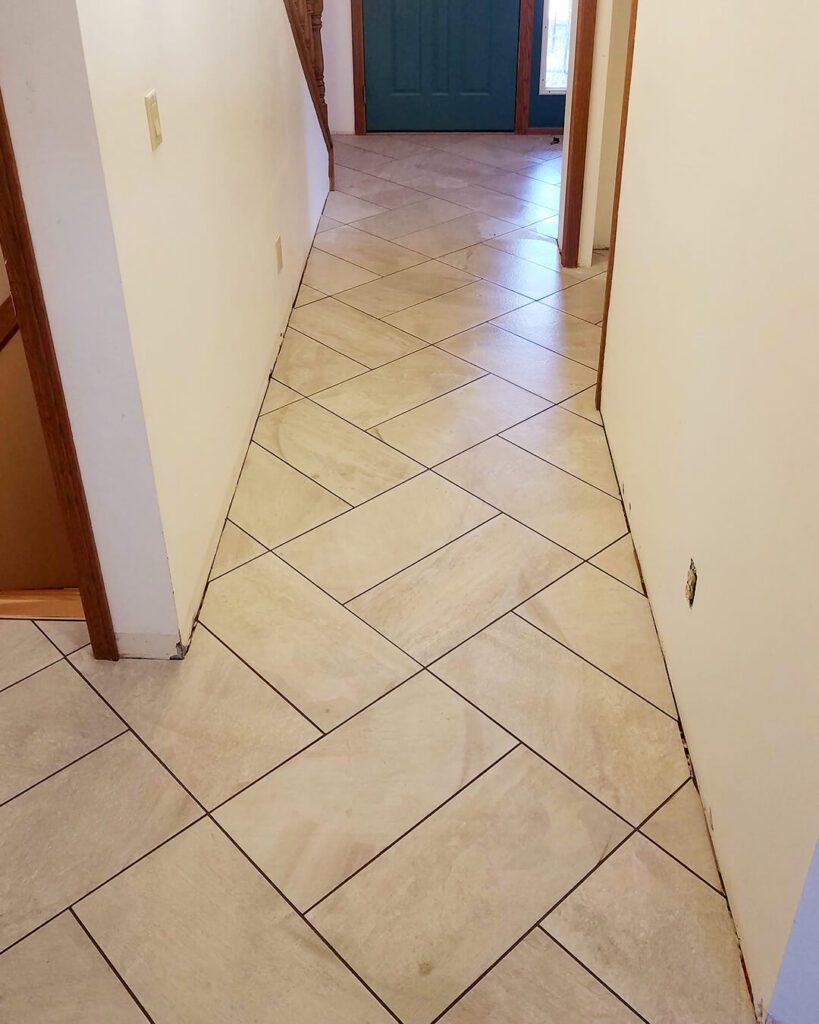 Neutral beige ceramic tile floor in diamond pattern – installed in hallway by Esox Custom Tiling