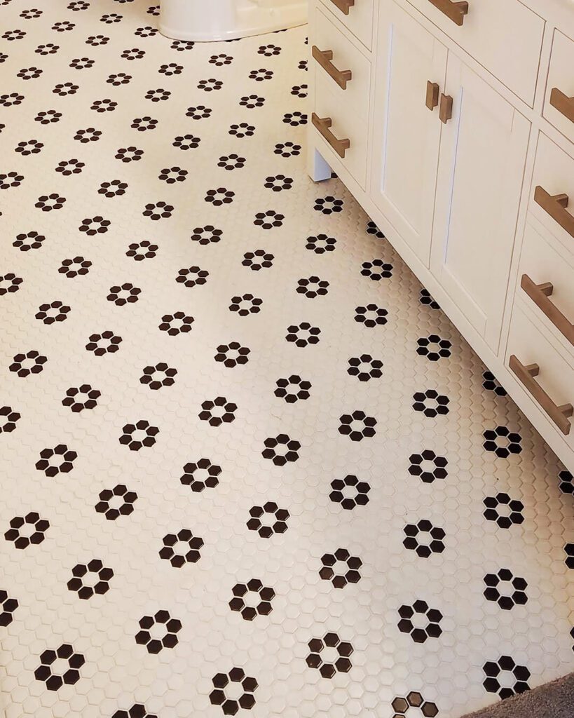 Mosaic tile floor with black and white floral pattern – vintage-inspired bathroom tile by Esox